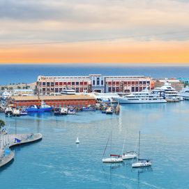 Barcelona cruise port, public promenade and cable car over Barceloneta at sunset