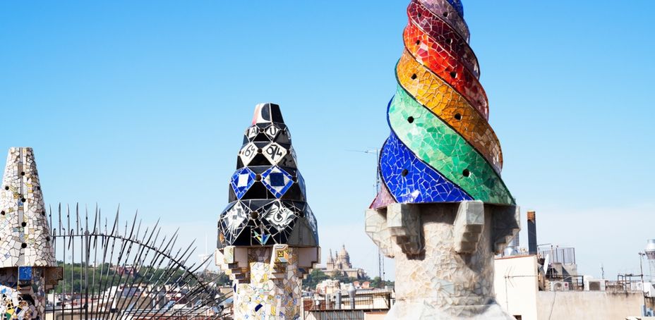 Colorful mosaic sculptures at the Palau Güell landmark in Barcelona.