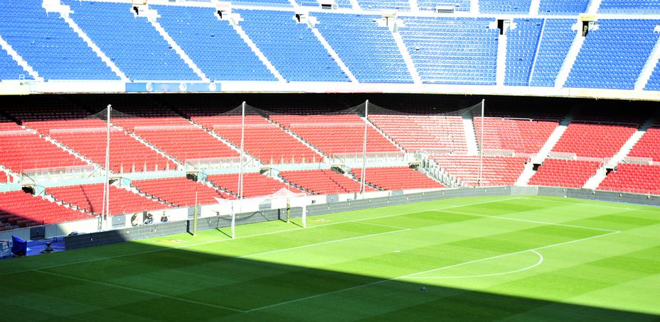 Empty Football Stadium with Blue and Red Seating Arrangement