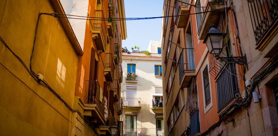 Streets of Barcelona Raval neighborhood seen on a sunny summer day with blue sky