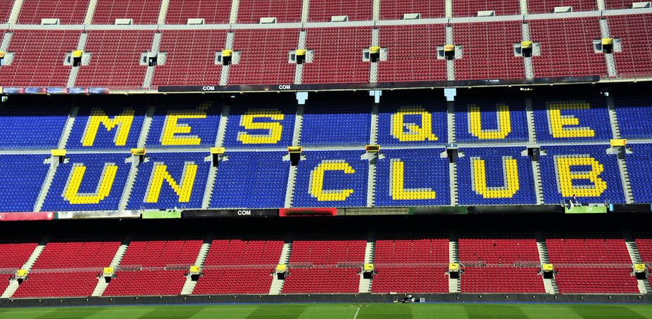 Empty Camp Nou Stadium Seats with MES QUE UN CLUB Slogan During Daytime