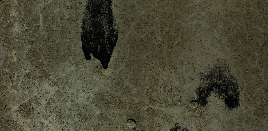 Concrete wall with pores and black graffiti texture