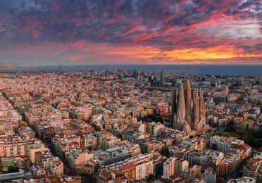 Barcelona, Spain. May 01, 2023. Aerial view of Barcelona City Skyline and Sagrada Familia Cathedral at sunset. Eixample residential famous urban grid.