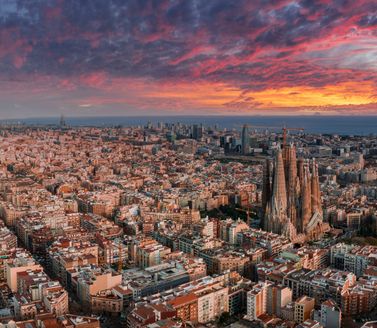 Barcelona, Spain. May 01, 2023. Aerial view of Barcelona City Skyline and Sagrada Familia Cathedral at sunset. Eixample residential famous urban grid.