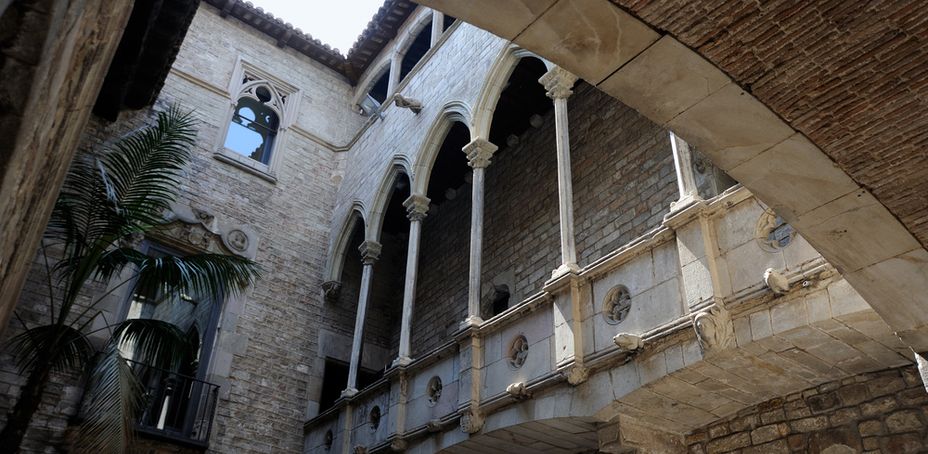 The interior of an old building with arched windows and ornate stonework