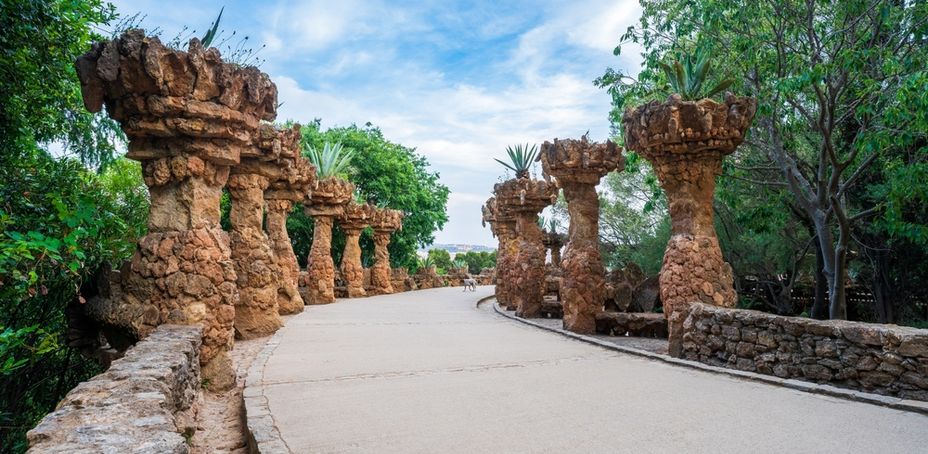 Pathway through ancient ruins in Park Güell, a famous landmark in Barcelona.