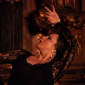 Flamenco dancer in a black lace dress performing passionately in Barcelona