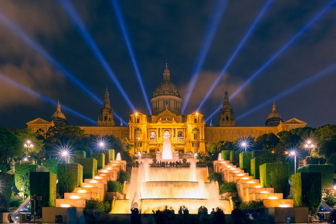 The MNAC illuminated at night with the Magic Fountain and light beams