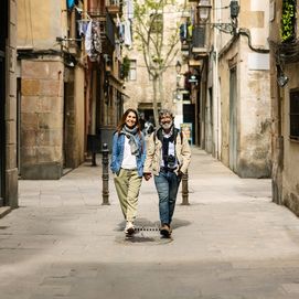 A couple strolling hand-in-hand through the charming streets of Barcelona