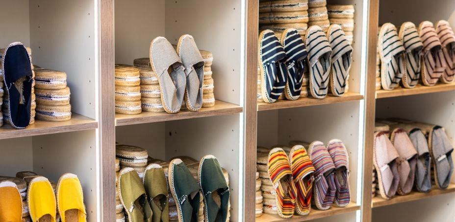 Shelves filled with colorful handmade espadrilles in a Barcelona shop