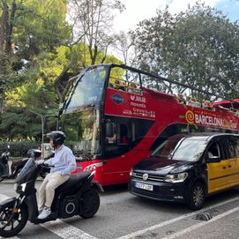 A red bus among Barcelona traffic