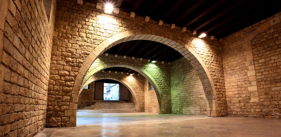 Entrance to the Picasso Museum featuring a historic archway in an old town setting.